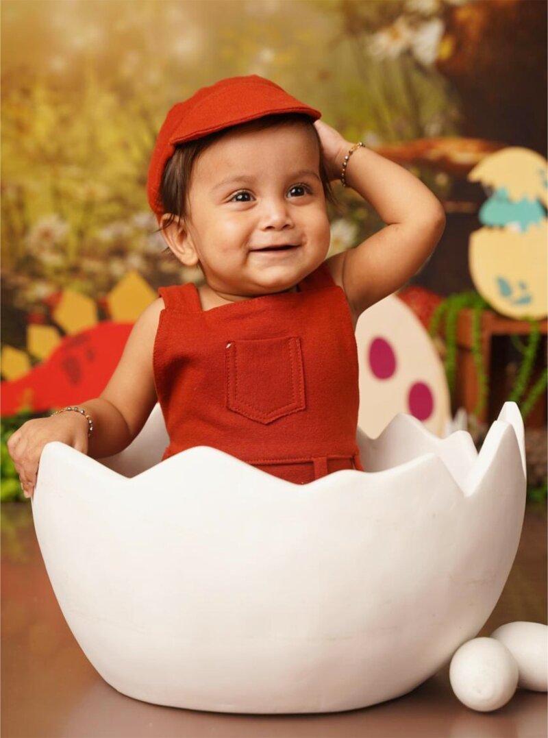 A playful baby photo, sketch-ready for crayons — the printed coloring-book page